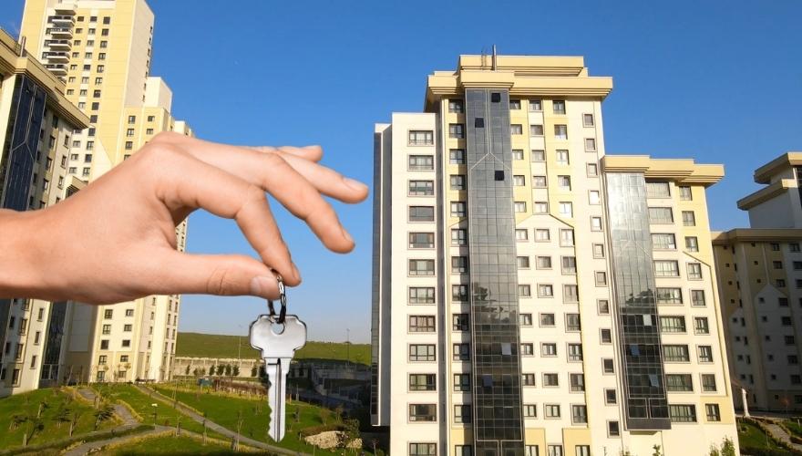 partment buildings with a hand holding a key, representing subsidized housing access.